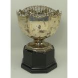 A silver rose bowl of octagonal form with an embossed rococo scroll rim, Birmingham 1947,