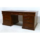 A hardwood partner's desk, nine drawers with brass swan neck handles, sectional leather skiver and