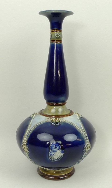 A Royal Doulton stoneware vase of long necked baluster form reserve decorated with floral sprigs