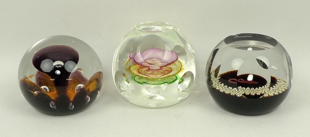 A group of Caithness glass paperweights comprising Ready Steady Go, Sunflower, and Christmas 1977.