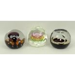 A group of Caithness glass paperweights comprising Ready Steady Go, Sunflower, and Christmas 1977.