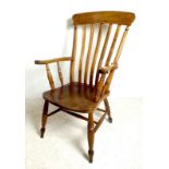 A Victorian oak and elm splat back kitchen carver chair, with turned supports joined by stretchers,