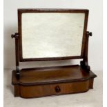A 19th century mahogany toilet mirror with cushion moulded frame, the shaped base with beaded
