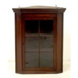 A Victorian glazed mahogany hanging corner cupboard with two shelves, and key, 74 by 41 by 95cm
