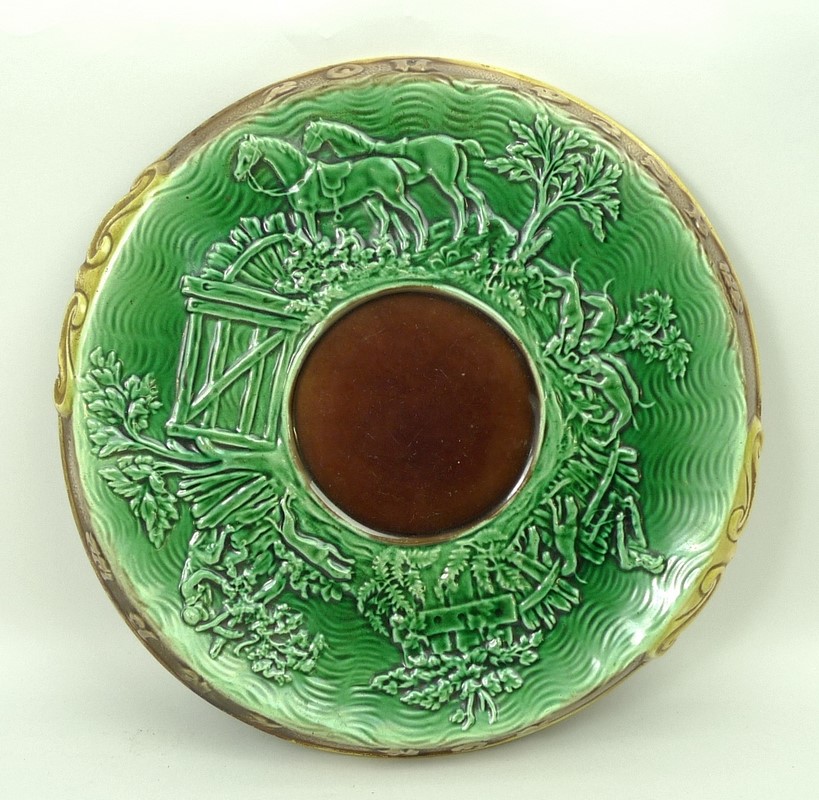 An Adams & Bromley majolica bread board, late 19th century,  moulded to the top with a hunting