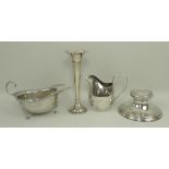 A silver cream jug of plain form, London 1908, sauce boat with a gadrooned rim, raised on three