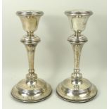 A pair of silver loaded candlesticks of baluster form, Birmingham 1912, 24.835toz total weight,