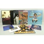 A collection of 45 rpm and LP vintage vinyl records including The Hotel California by the Eagles.