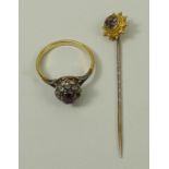 A ruby and diamond ring, size L, together with a 9ct gold and gem set flower head stick pin, 3.6g.