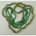 A multi-tonal jade bead necklace, the pale beads streaked with pale green, violet and umber, and a