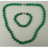 A jade bead necklace and a matching bracelet, each on an 18ct white gold snap clasp.