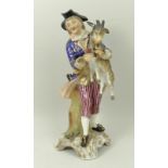 A Sitzendorf porcelain figure, late 19th century, modelled as a boy holding a goat and pan pipes,