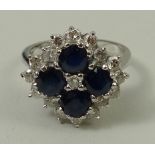 An 18ct white gold, sapphire and diamond cluster ring, diamonds approximately 0.6ct, size O, 6.3g.