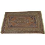 A Northern Persian / Iranian flat weave carpet with central medallion, navy motifs on a terracotta