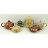 A group of five Chinese Yixing pottery teapots, two buff coloured, one of double gourd form painted