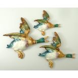 A group of three Beswick pottery graduated flying ducks, 596/2, 596/3 and 596-4, 23 by 22cm to 15