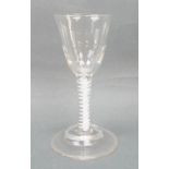 A George III wine glass, circa 1760, the funnel bowl with faint moulded fluting, raised on an