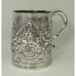A George I silver Britannia standard mug, later embossed with flowers and rococo scrolls, Humphrey