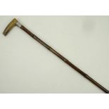 A 19th century horn and bamboo sword stick with white metal ferrule, 88cm long.