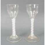 A pair of George III cordial glasses, circa 1780, the pan tops above a straight double opaque twist