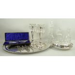 A pair of plated candlesticks with glass lustre drops, an oval plated tray,