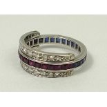 An alternating sapphire and ruby set white metal eternity ring,