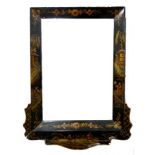 A Regency Chinoiserie black lacquer wall mirror decorated with flowers and figures in a garden,