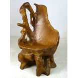 A 20th century carved wooden chair, of naturalistic form, 72 by 62 by 112cm high.