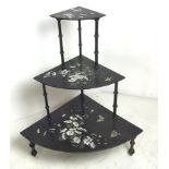 A black lacquered Japanese three tier set of graduated shelves, 70 by 50 by 81cm high.