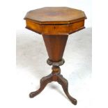 A Victorian octagonal top work box with tapered column and carved tripod base,