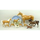 A Beswick Palomino racehorse, 28cm, a Beswick pony, 17cm, four Beswick foals, 8cm,