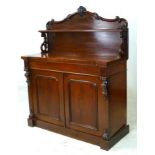 A Victorian mahogany chiffonier, with shaped and carved back and two doors, 120 by 49 by 149cm high.