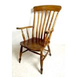 A Victorian oak and elm splat back kitchen carver chair, with turned supports joined by stretchers,