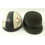 A hard hat with two peaks,covered in green houndstooth check fabric, labelled Ellandee,