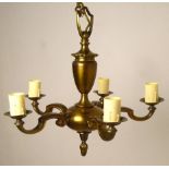 A Belgian brass five branch chandelier, and a composition single wall light painted gold,