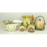 A Clarice Cliff 'Autumn Crocus' preserve pot, coffee can, Bizarre demi lune sauce boat,