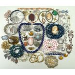 A quantity of silver and costume jewellery including hardstone set brooches, pendants,