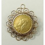 A Victorian half sovereign, date obscured, in a 9ct gold scrolling pendant mount, 8.9g.
