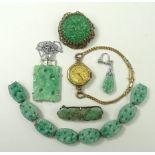 A jade brooch, circa 1920's, carved with a bat and fruit, Art Deco simulated jade pendant on chain,