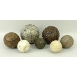 A quantity of golf and other sporting balls, comprising four featherie balls, 7cm, 6.5cm, 6cm and 4.