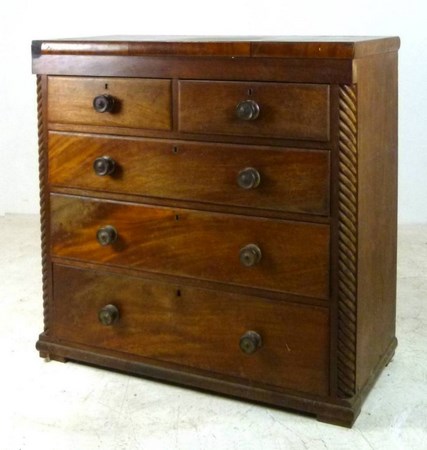 A Victorian rosewood and mahogany chest of drawers, with two short over three long drawers,