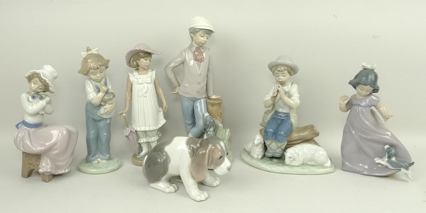 A Lladro porcelain figure of a puppy and six Nao figures comprising a shepherd, girl with parasol,