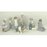 A Lladro porcelain figure of a puppy and six Nao figures comprising a shepherd, girl with parasol,