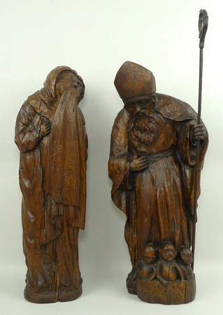 A Continental wooden sculpture modelled as St Nicholas with the three resurrected children in the