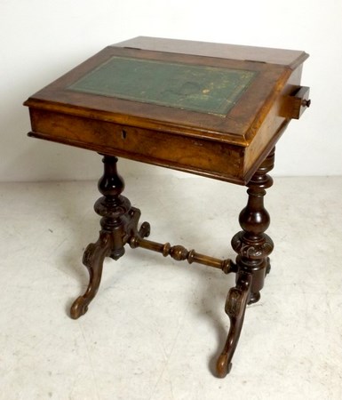 A 19th century rosewood Davenport desk, the writing slope lid with green leather skiver,