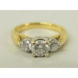 An 18ct gold, platinum and three stone diamond ring in a stepped design, approximately 0.