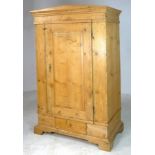 A Victorian pine wardrobe of architectural form with a single door and drawer below,