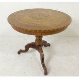 An 18th century parquetry table, inlaid with a starburst, raised on a tripod base,