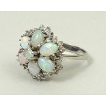 An 18ct white gold and opal dress ring, of flower head form,