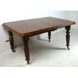 A Victorian mahogany wind out extending dining table, with one additional leaf,
